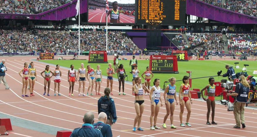 a group of people standing on top of a race track