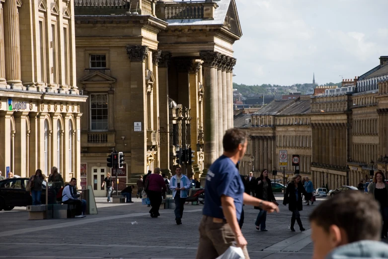 people walking in front of a tall building