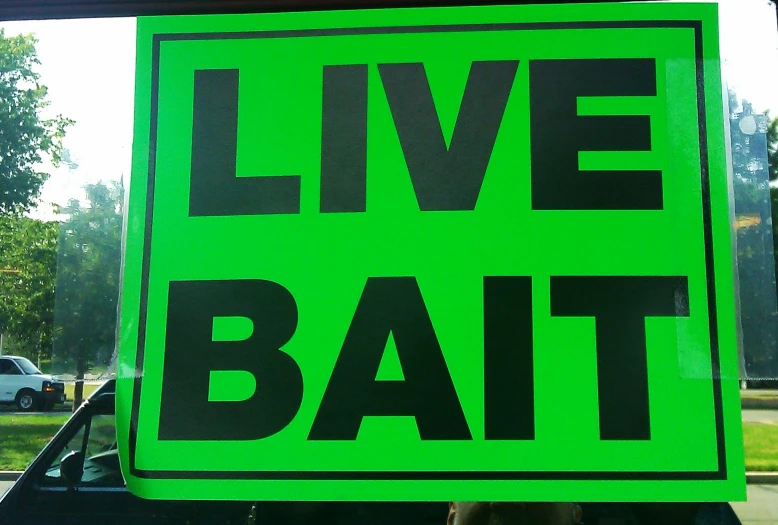 a sign that is saying live, bat, and in the street