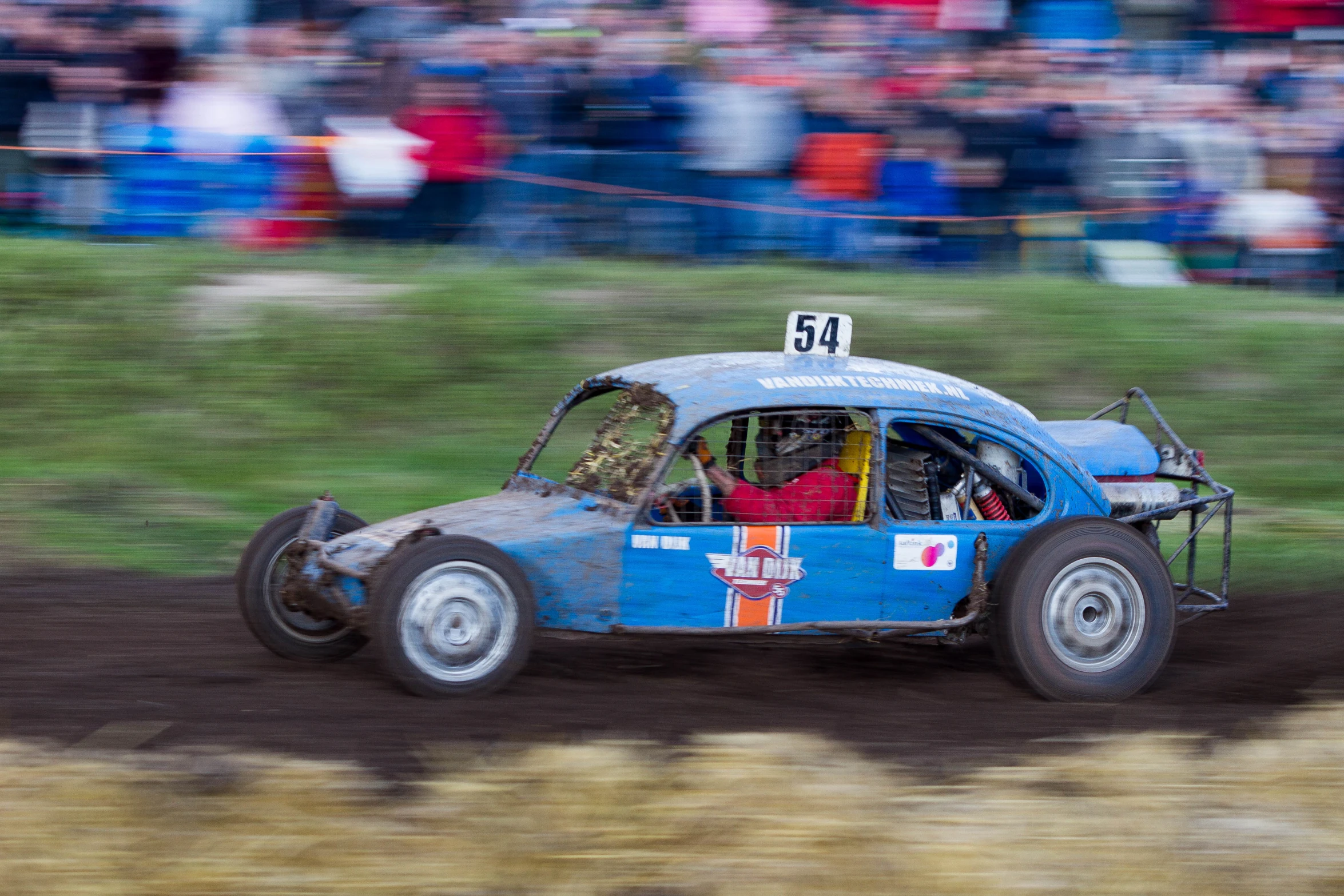 a car with two large tires in the dirt