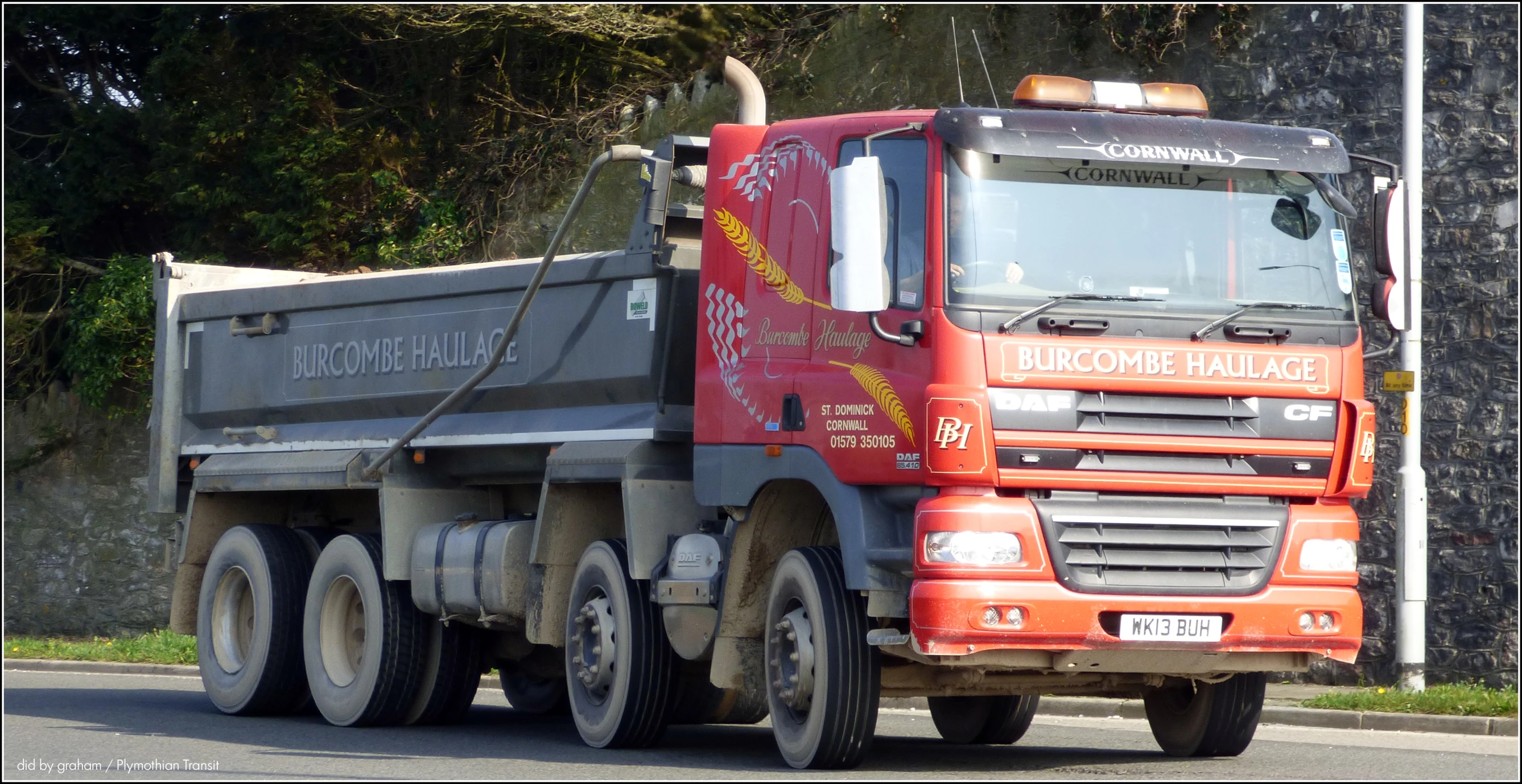 a dump truck is hauling a trailer down the street