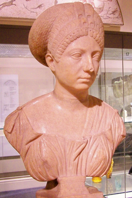 a sculpture of a woman with a hat on her head