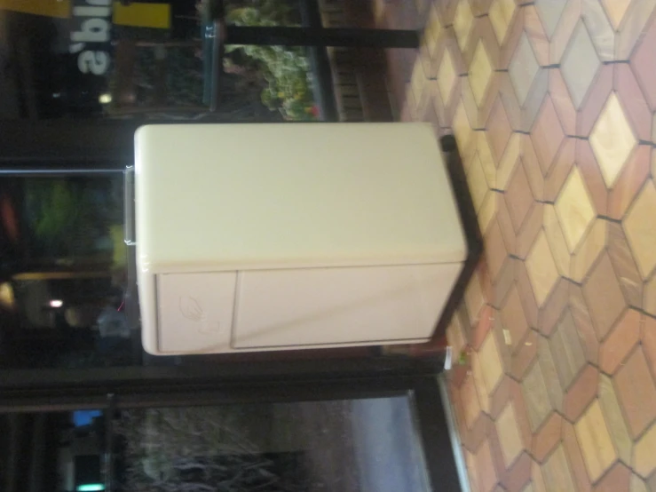 a refrigerator sitting outside in front of a restaurant window