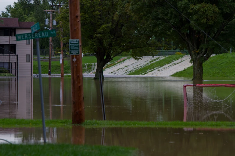 a flooded street and green buildings under water