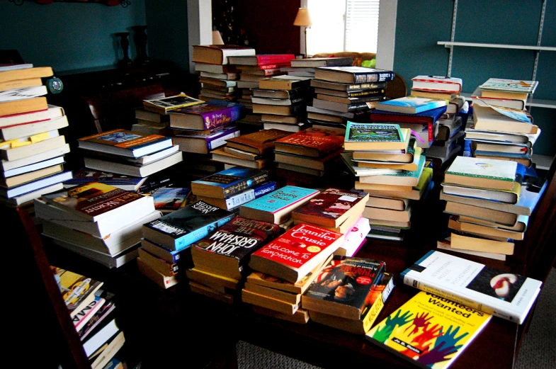 large stack of books on top of a table
