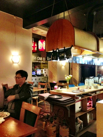a restaurant bar has an oriental style counter and light fixtures