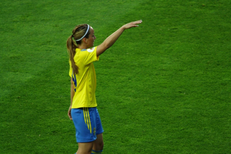 woman on the field playing soccer with ball