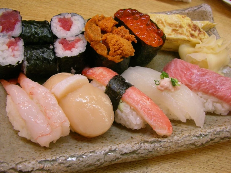 a plate full of sushi on a table