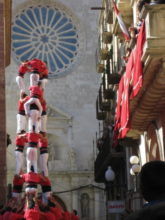 the two men are standing in the air wearing red and white attire