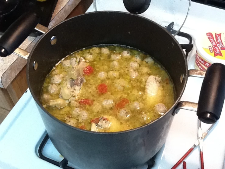 a pot of food cooking on a stove top