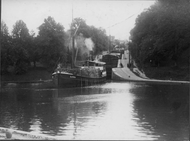 two tug boats are in the water next to a ramp