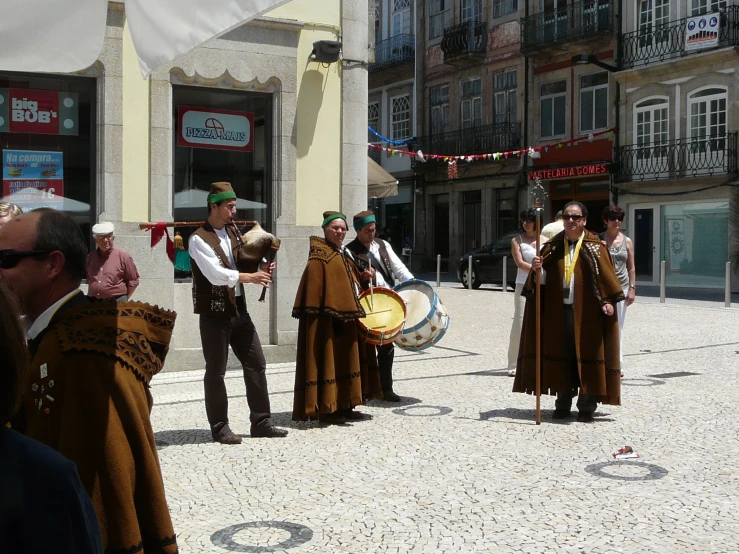 men in traditional costumes performing on the street