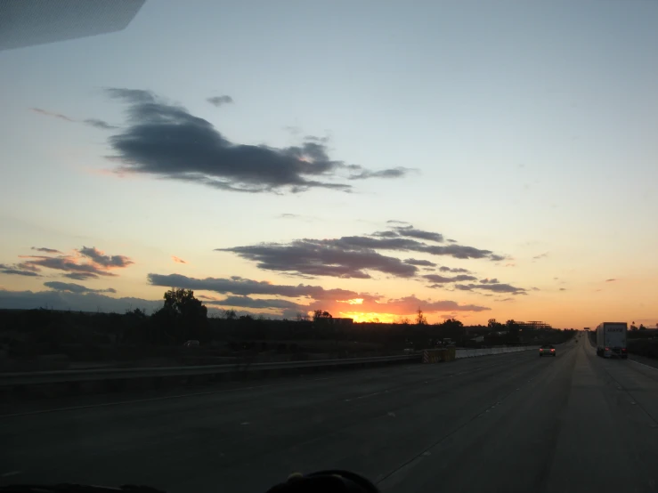 the sunset as seen from the inside of a vehicle