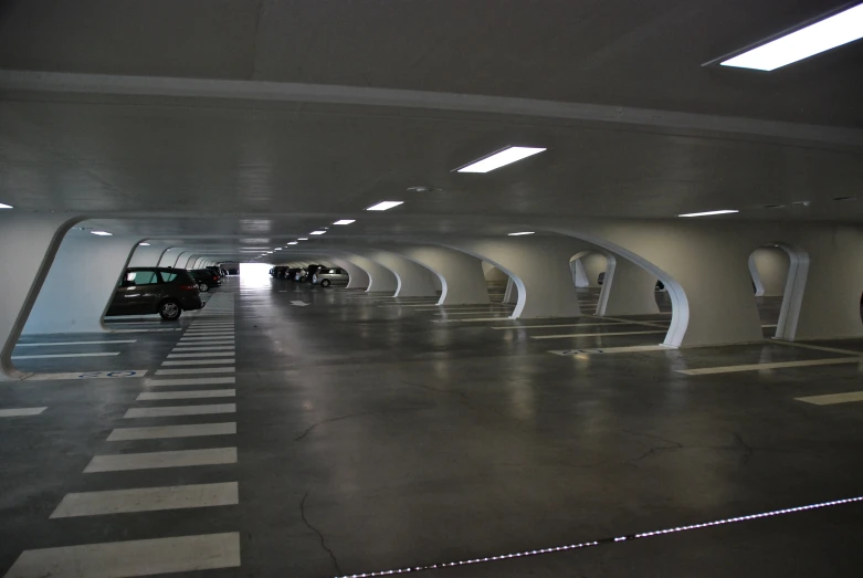 a car driving through an empty parking garage