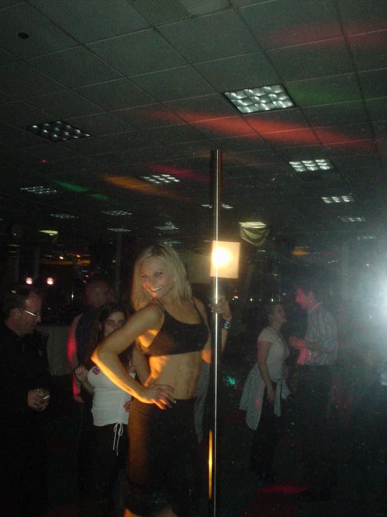 the woman is dancing with others in the club