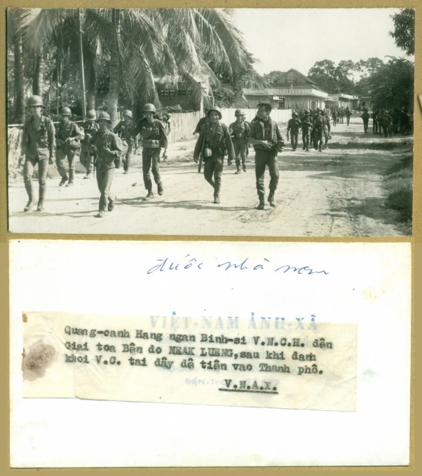 an old picture of men walking through a village