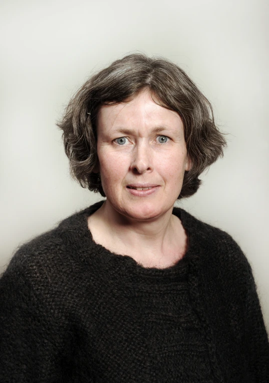 a woman with short hair looks at the camera