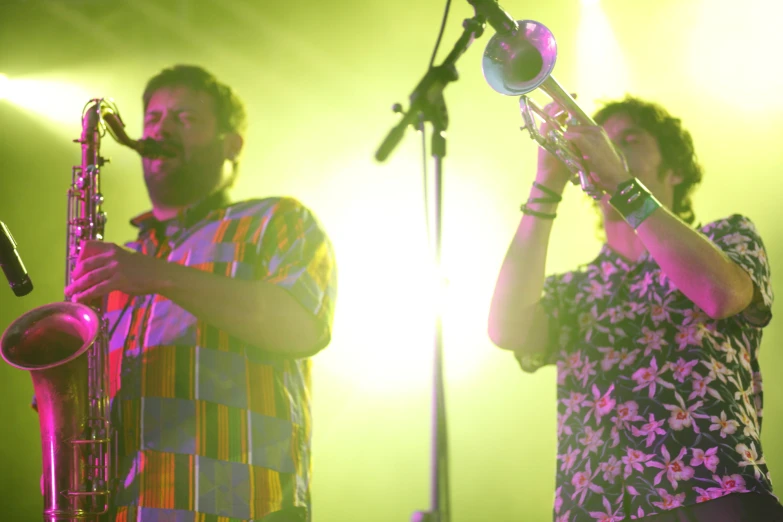 two men are playing music on the stage