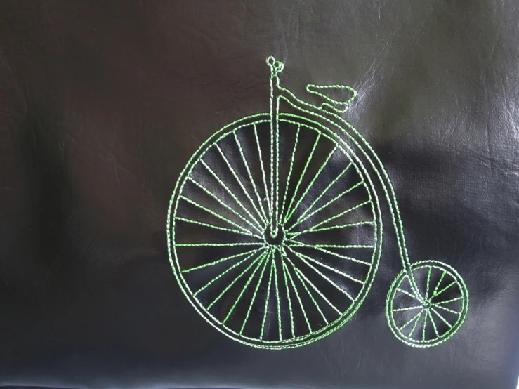 a piece of string is hand embroideryted onto a bicycle