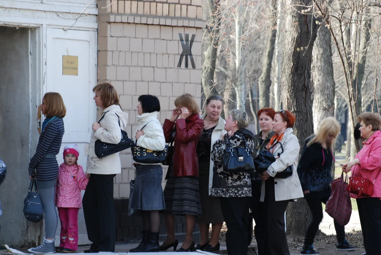 people stand outside and laugh at the person on the far left