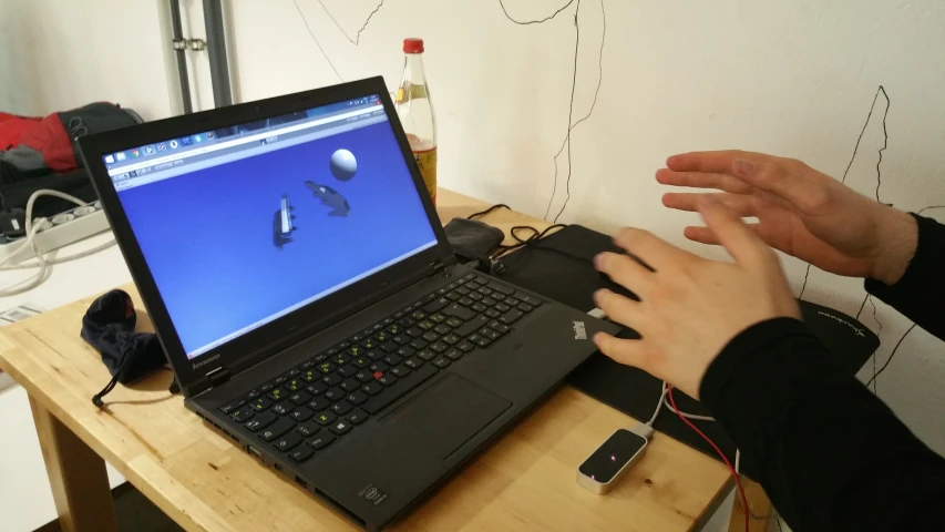 a person has his hands on the keyboard of a laptop