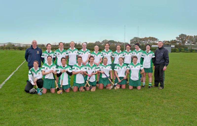 a girl's soccer team posing for a group picture