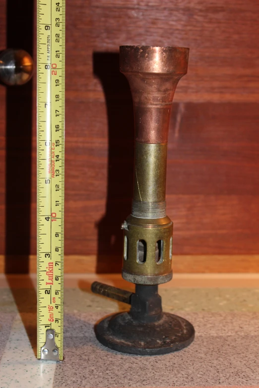 a metal pillar next to a measure line