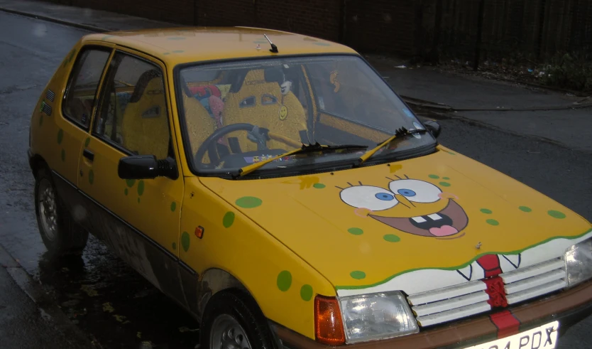 a yellow car decorated with images of spongebob characters