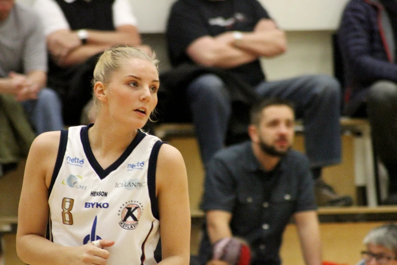 a women who is playing basketball and talking to someone