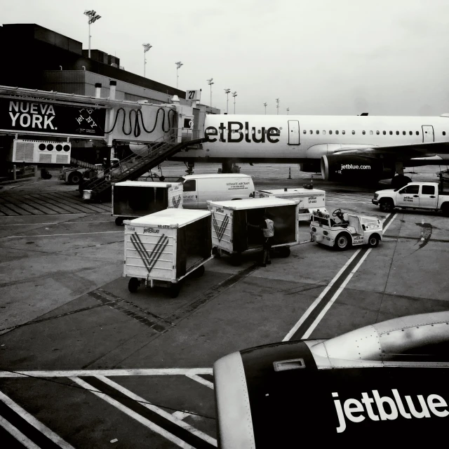 a jet blue jetliner sitting on top of an airport tarmac