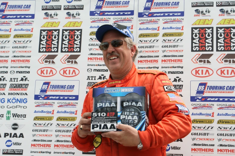 a man in an orange and black outfit is holding a book