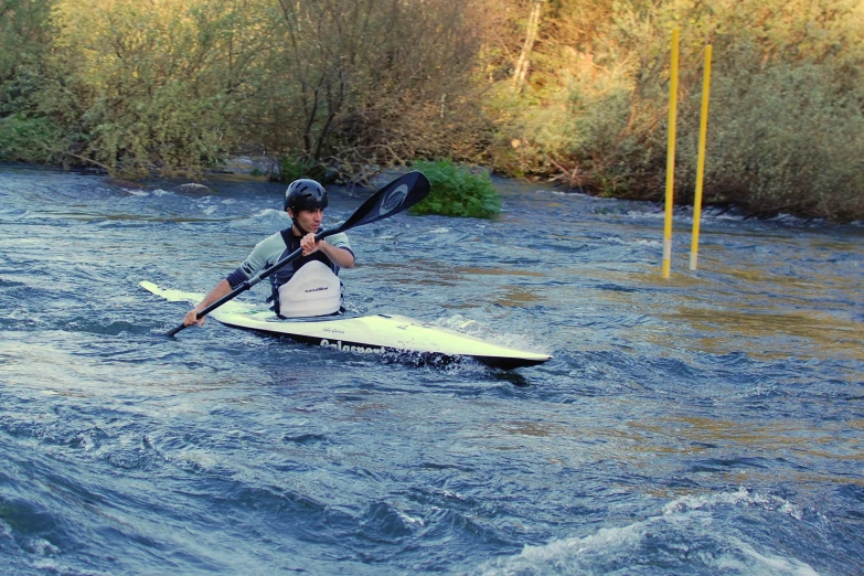 a man riding a paddle board on a river