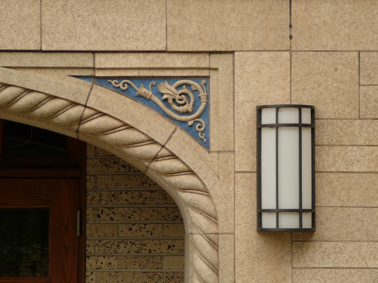 the entrance to a building with ornate windows and tile work