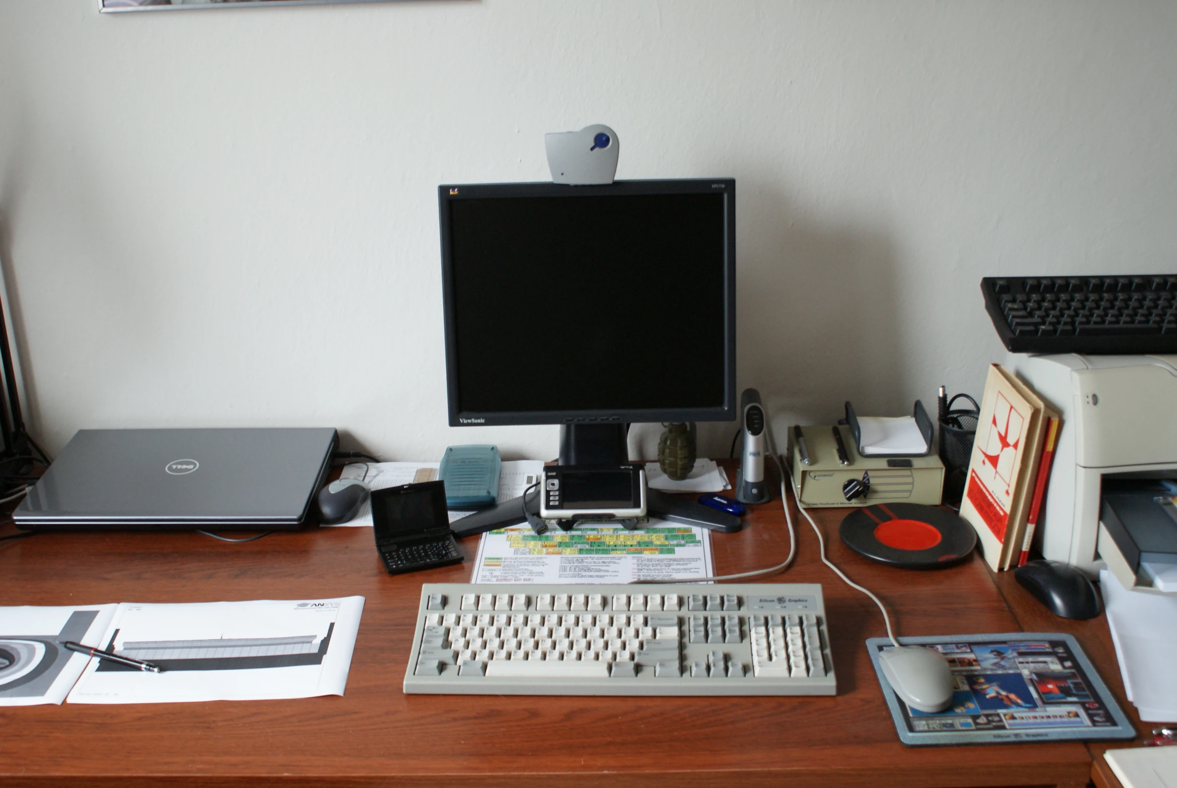 there is a desktop computer and various other items on the table