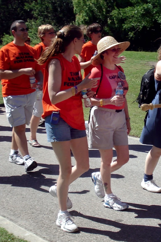 the runners are wearing orange shirts