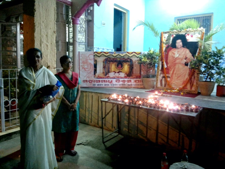 two women watching an image of a lady in the temple