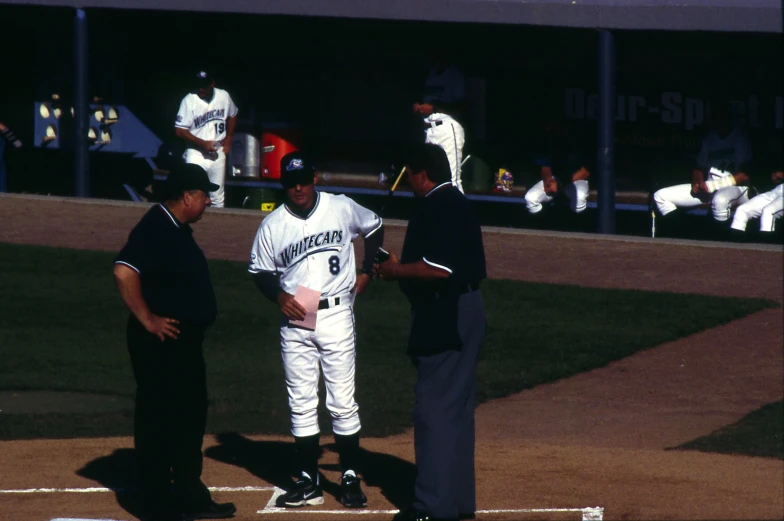 a baseball player getting ready to play with an umpire