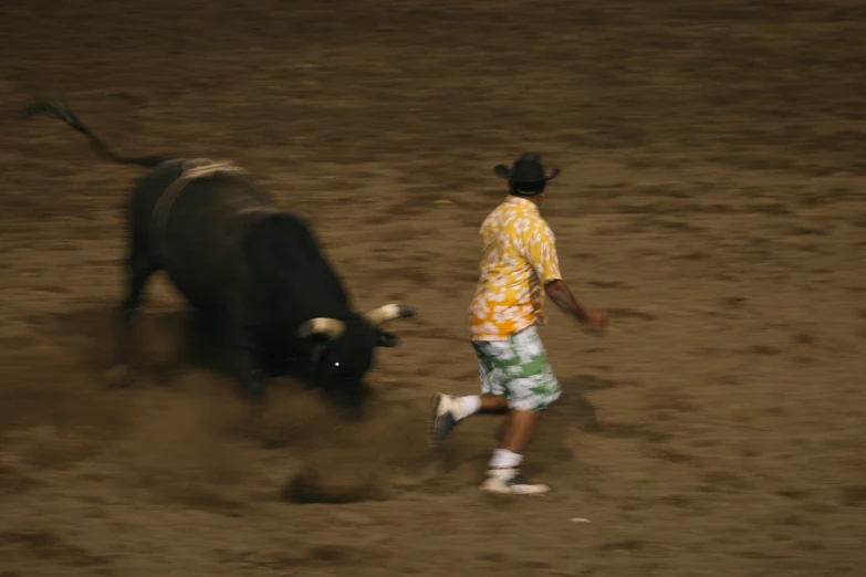 the rodeo is taking place on an open dirt lot