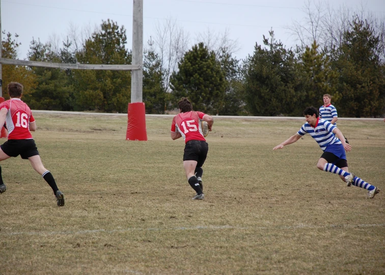 there are several players on this field one is trying to get the ball