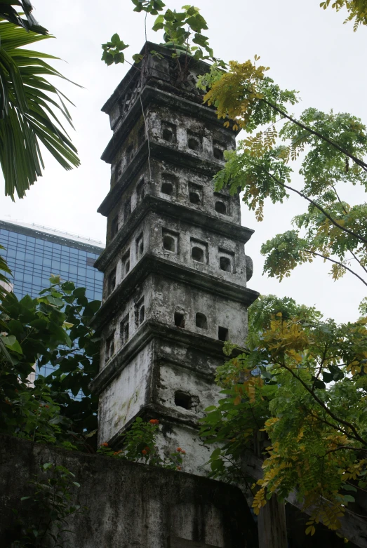 a tall tower is shown near some trees