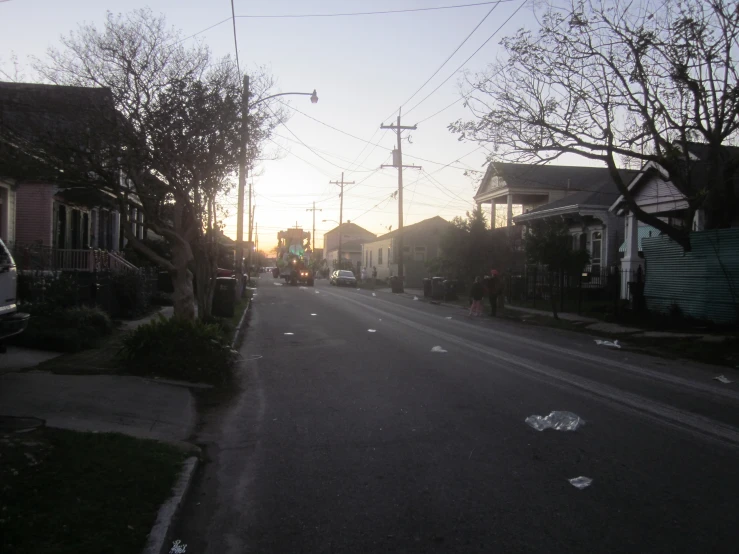 a deserted street lined with houses on both sides