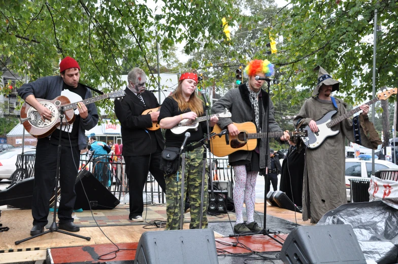 a band playing at an event with people standing and sitting around