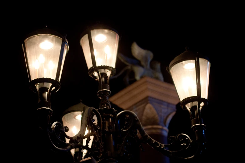 a street light with three lights lit next to it