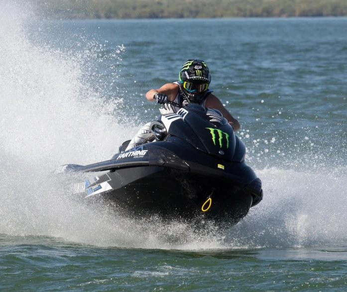 a man riding a jet ski while water is splashing over