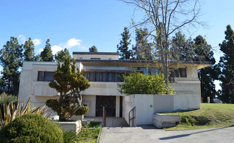 a large modern building with trees and blue sky