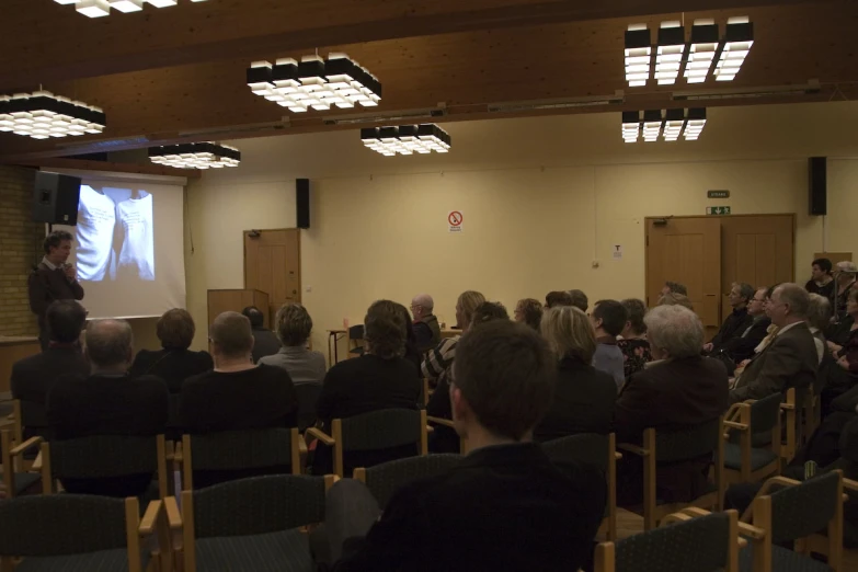 the audience is listening to the lecture on manhood