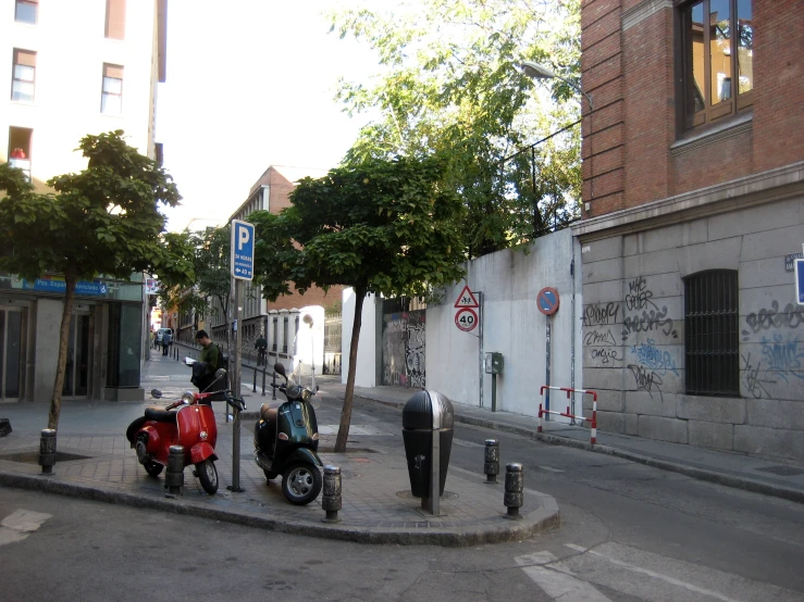 three motorcycles are parked in the middle of a street