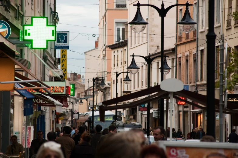 many people walking down the street in a city