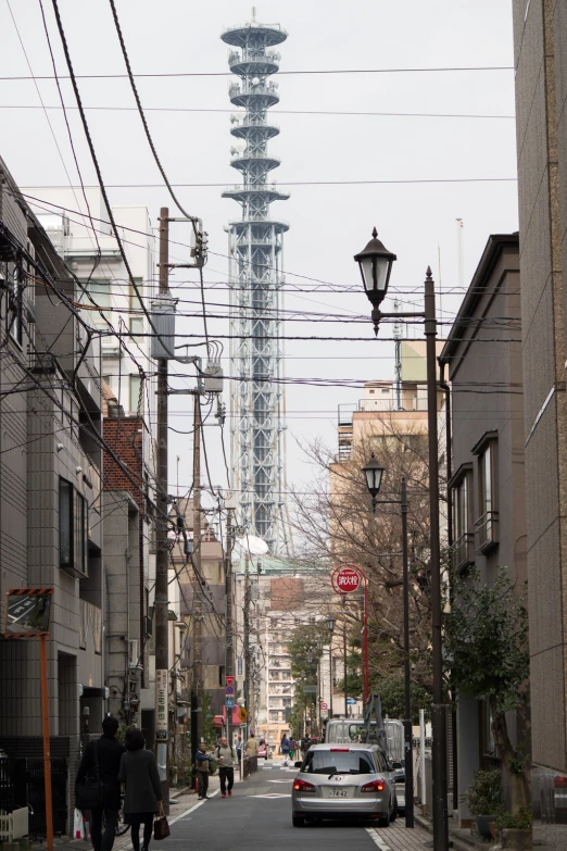 a street in an urban area with a car driving down it