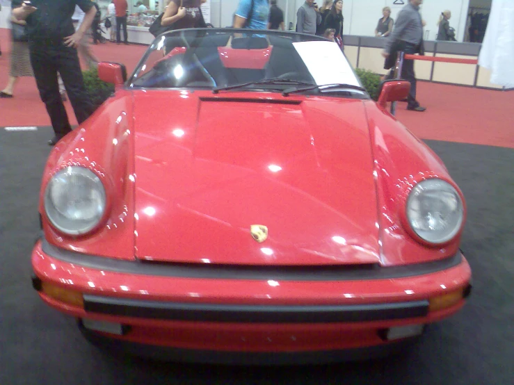 there is a red ferrari parked inside a showroom